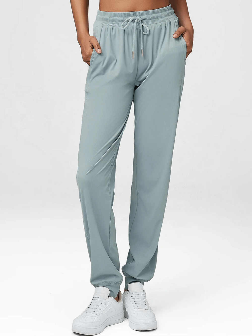 Women's breathable drawstring pants in cool light green, ideal for leisure or activity. Made of durable nylon-spandex blend.